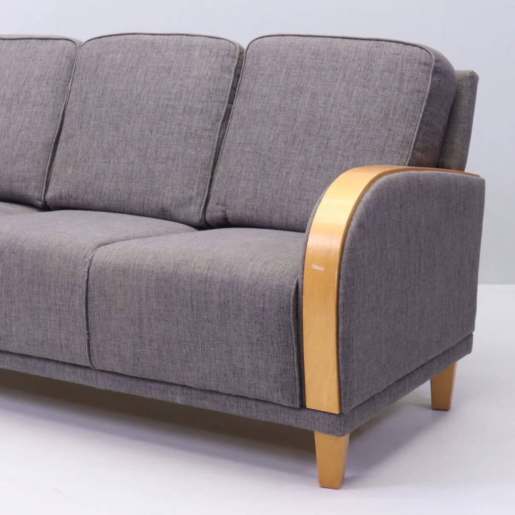 Three-seater Art Deco style sofa in grey fabric and curved wood.
