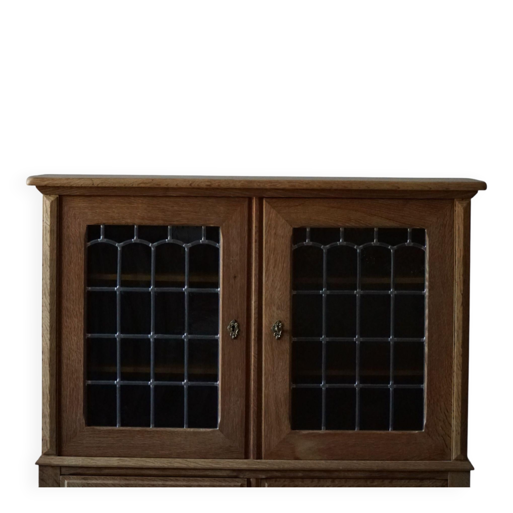 20th-century mid-century solid oak sideboard with glass front, by a Danish cabinetmaker.