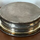 Antique silver-plated bottle coaster with floral decoration.