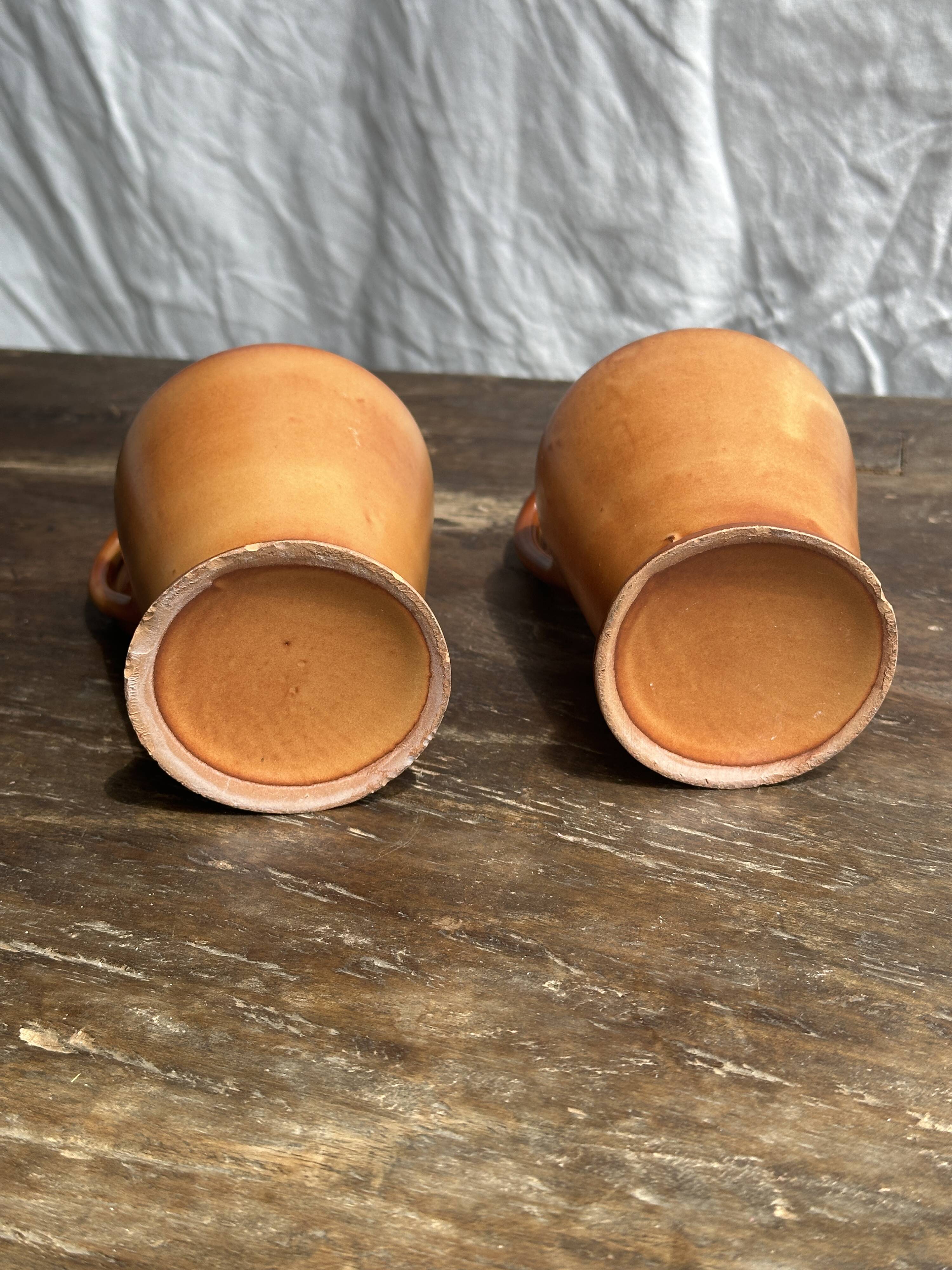 Pair of mini orange stoneware pitchers