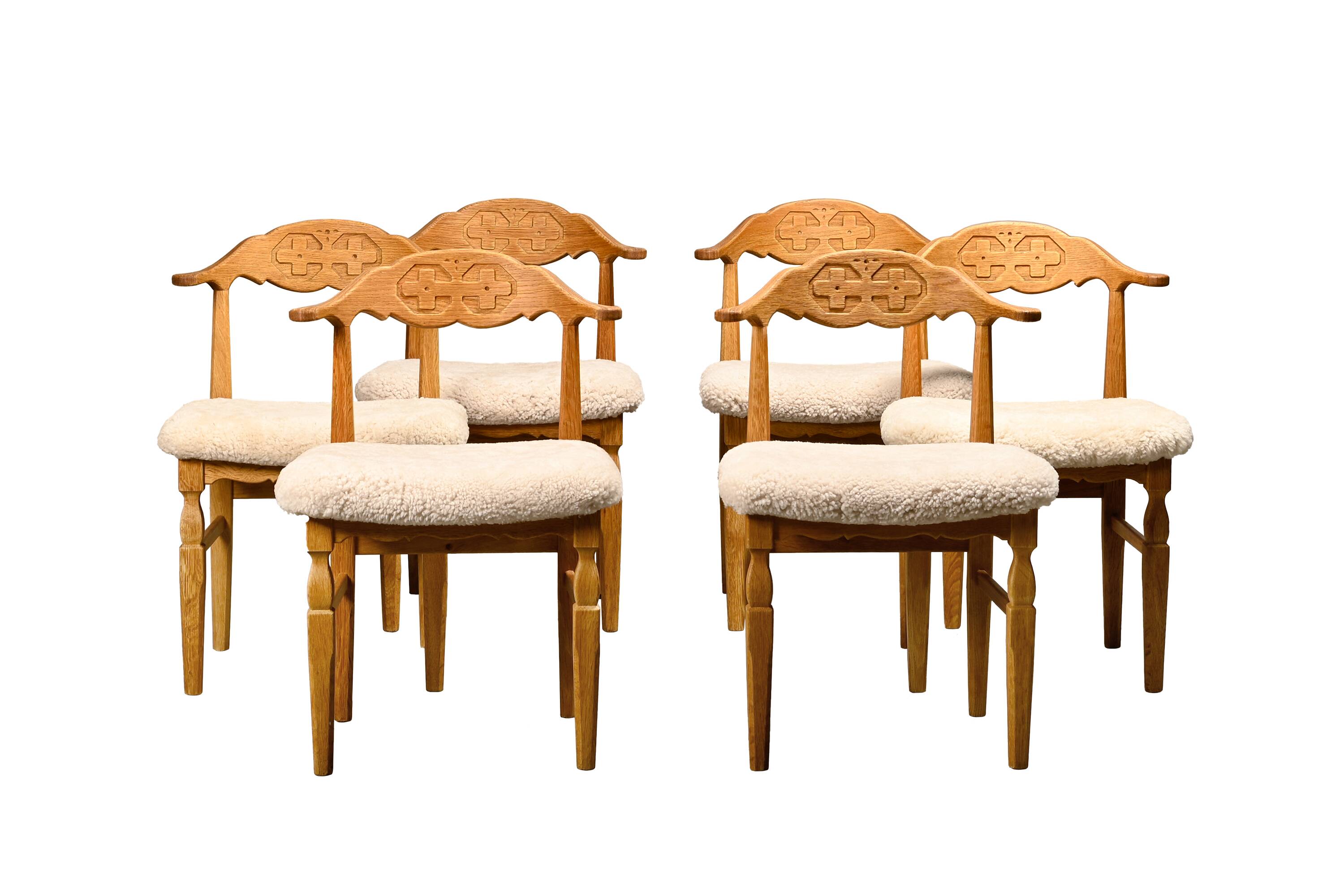 Henning Kjærnulf dining chairs set in Oak and Sheepskin, Denmark, 1960s