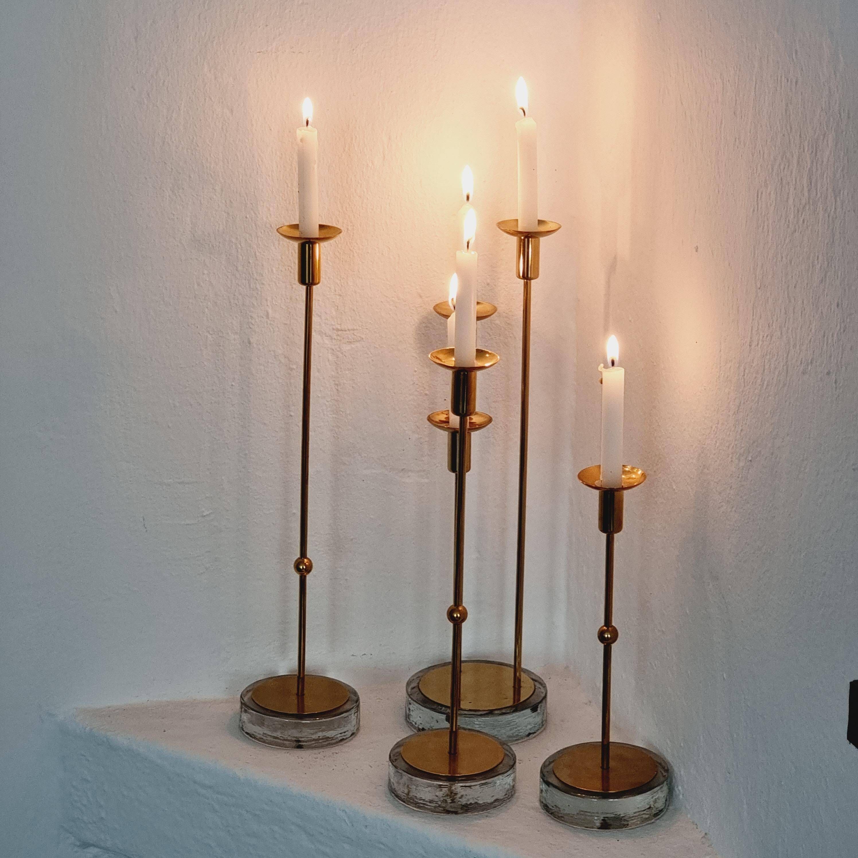 Gunnar Ander, four candlesticks, brass and glass, Ystad Metall, Swedish modern.