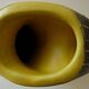 Earthenware vase decorated with yellow lines on a black and yellow background