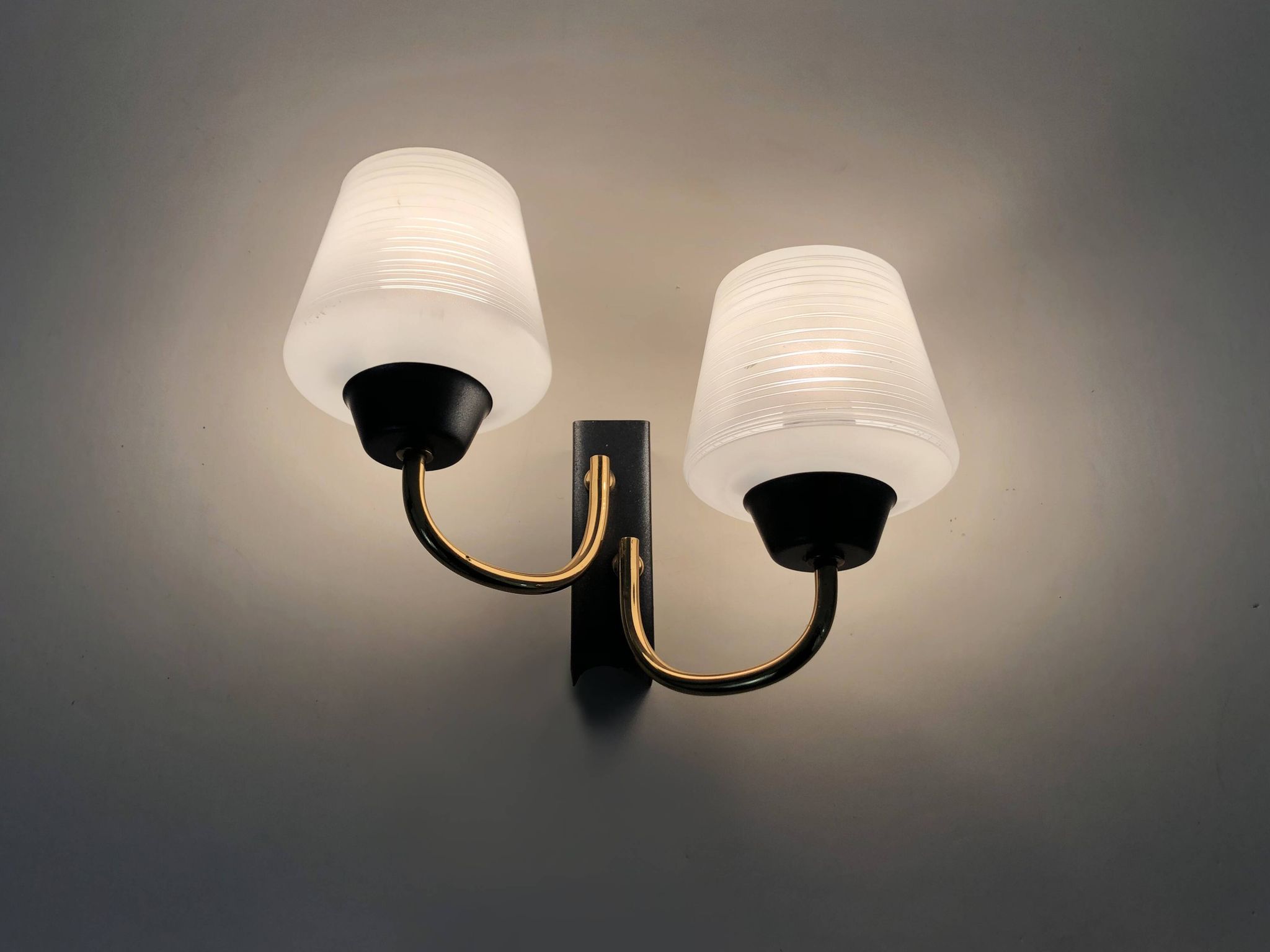 Pair of vintage Maison Arlus wall lights from the 1950s in brass, glass globe.