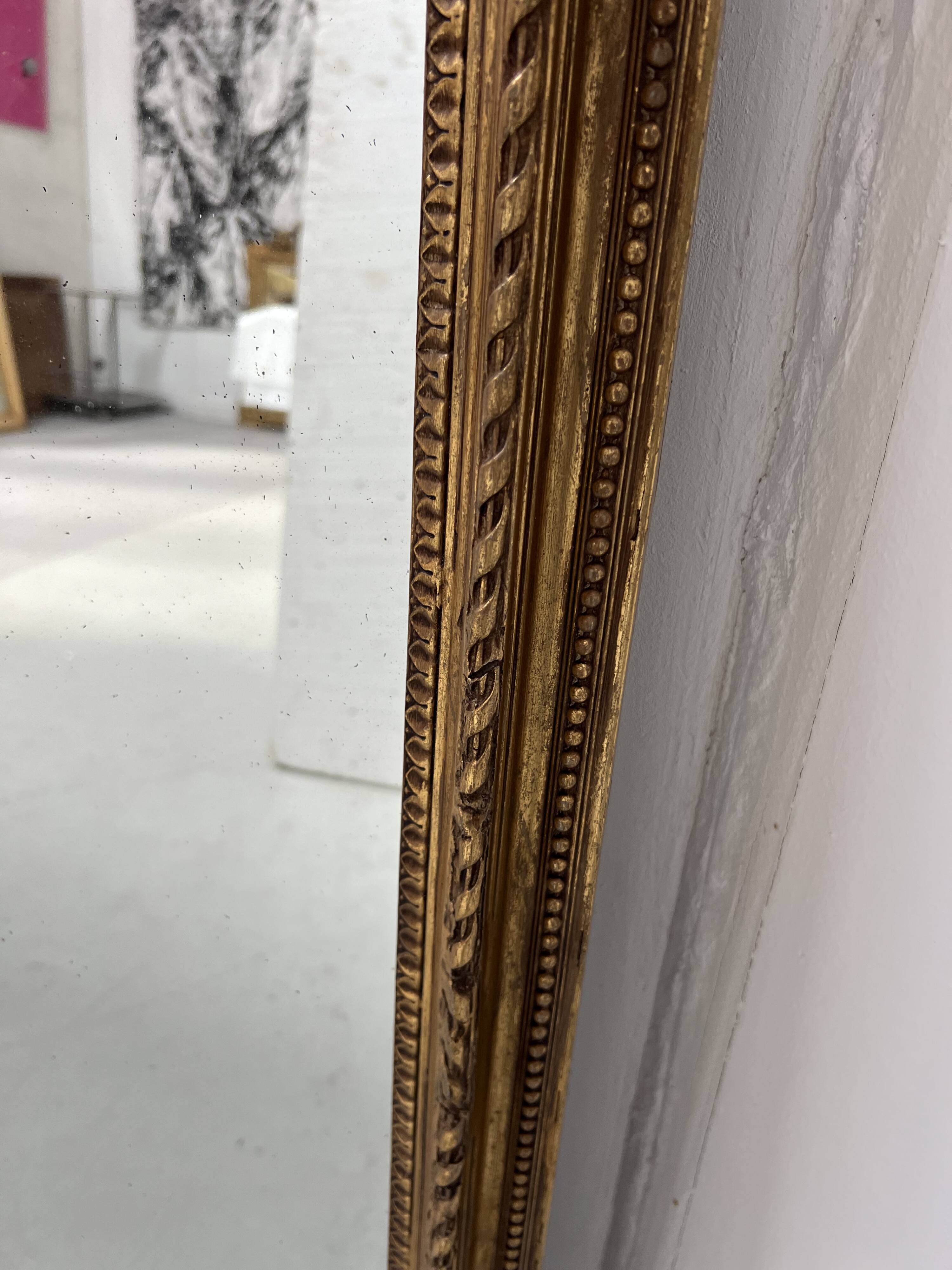 Louis XVI style mirror in wood and gilded stucco, 19th century