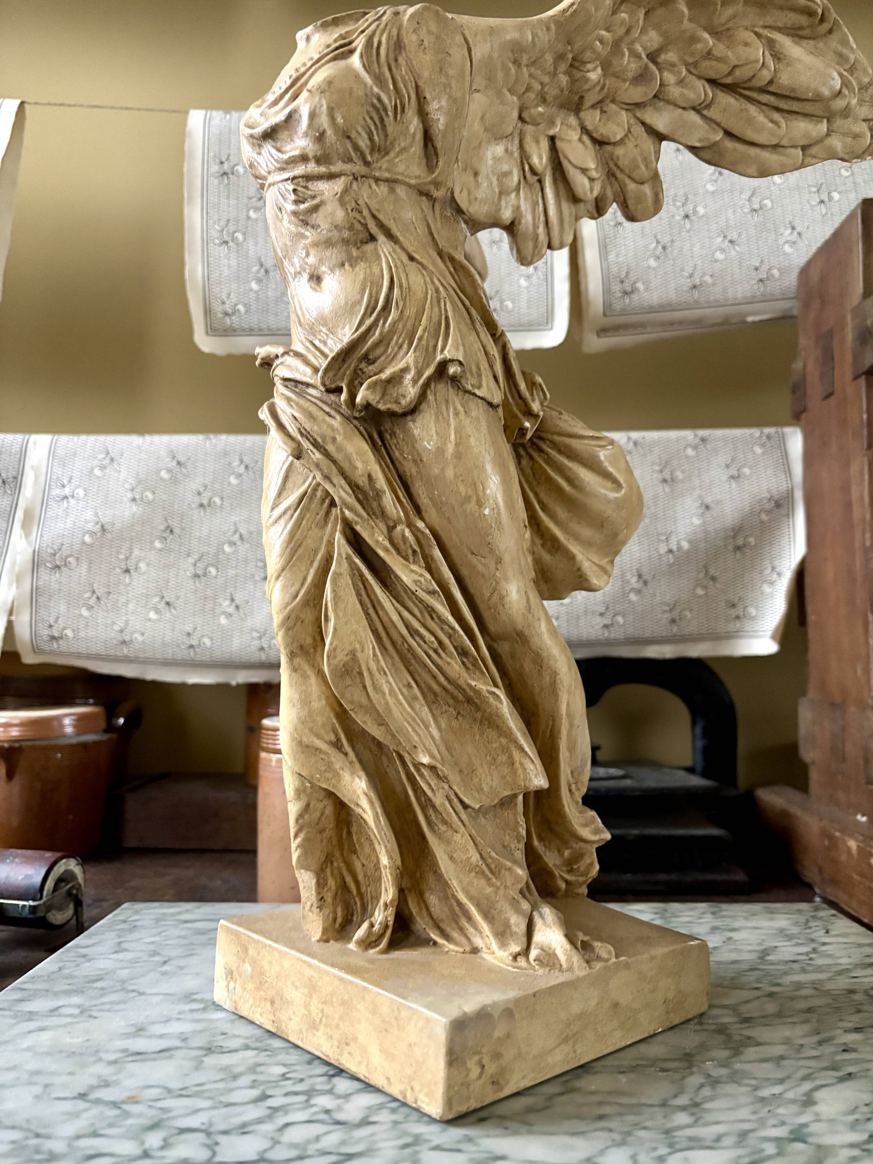 "Winged Victory of Samothrace", beige plaster statuette