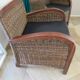 2 colonial-style armchairs in woven rattan and exotic wood