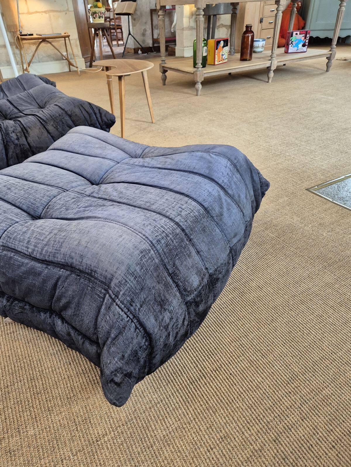 Togo sofa by Ligne Roset and its pouf from the 1970s.