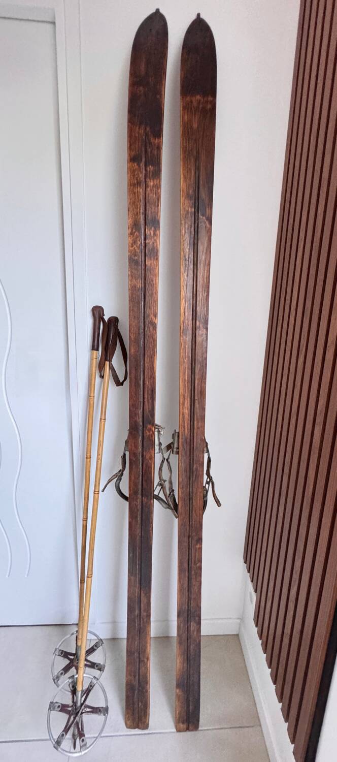 Antique wooden skis with vintage poles