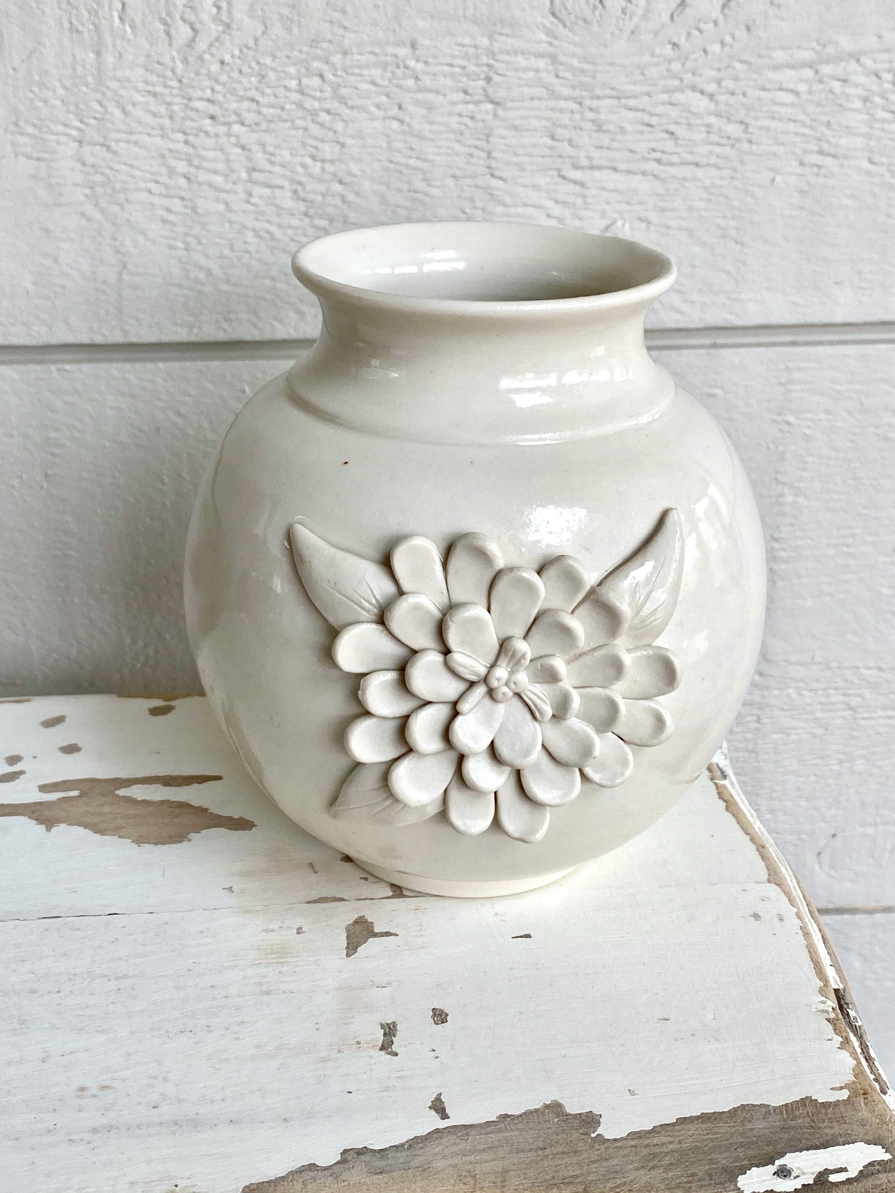 Small ceramic vase with floral relief