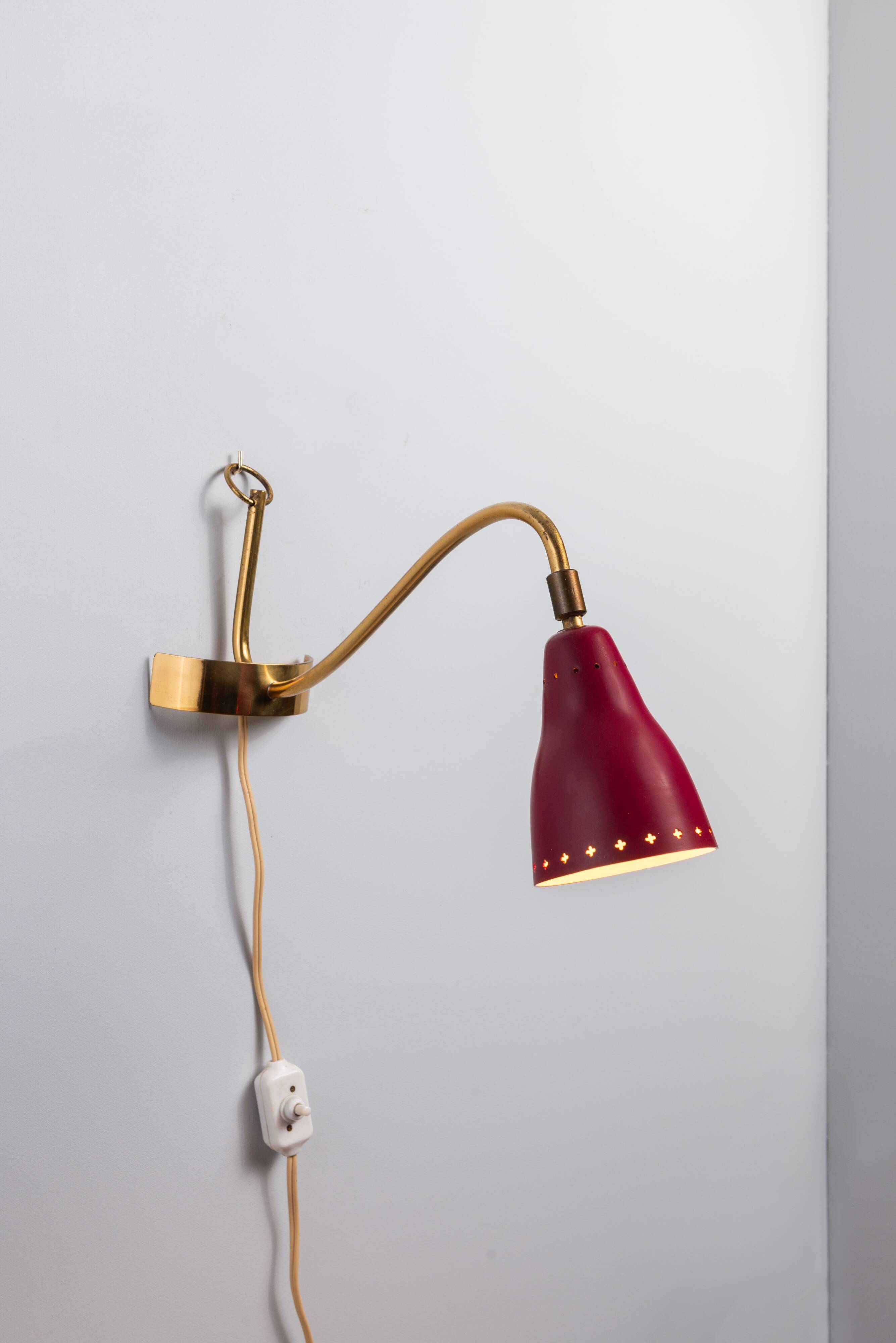 Brass wall lamp with perforated metal shade, 1950s, Sweden