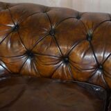 Victorian Chesterfield leather upholstered canapé with feather cushions.