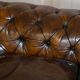 Victorian Chesterfield leather upholstered canapé with feather cushions.