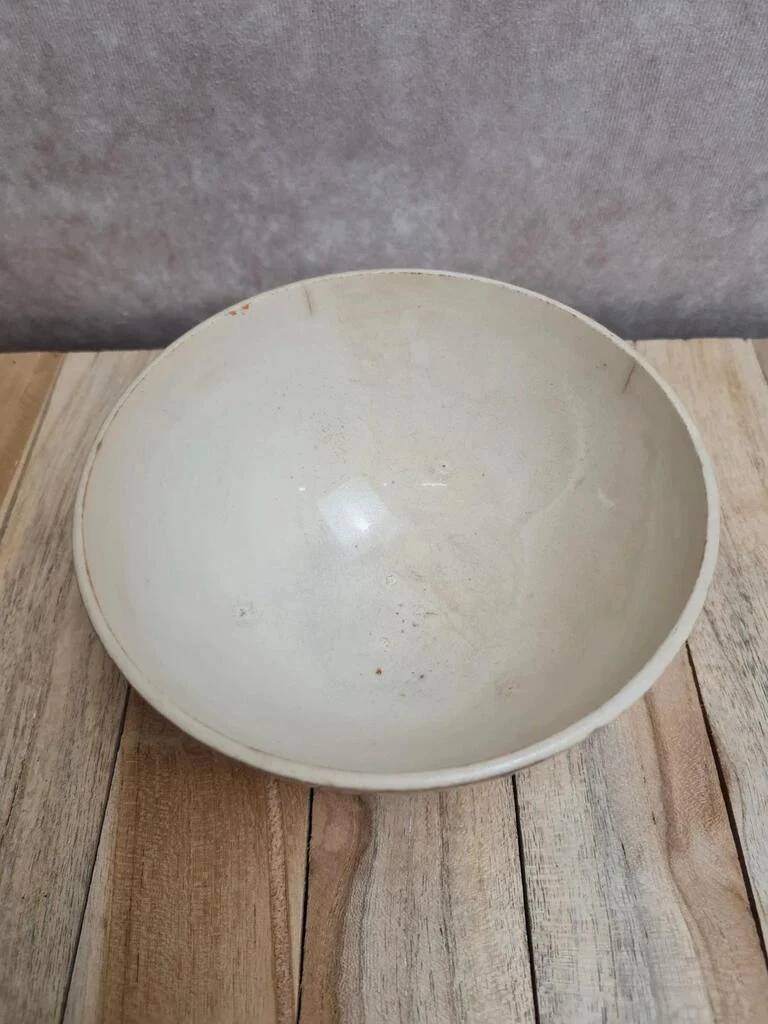 Old ironstone bowl with vintage blue and ochre decoration.