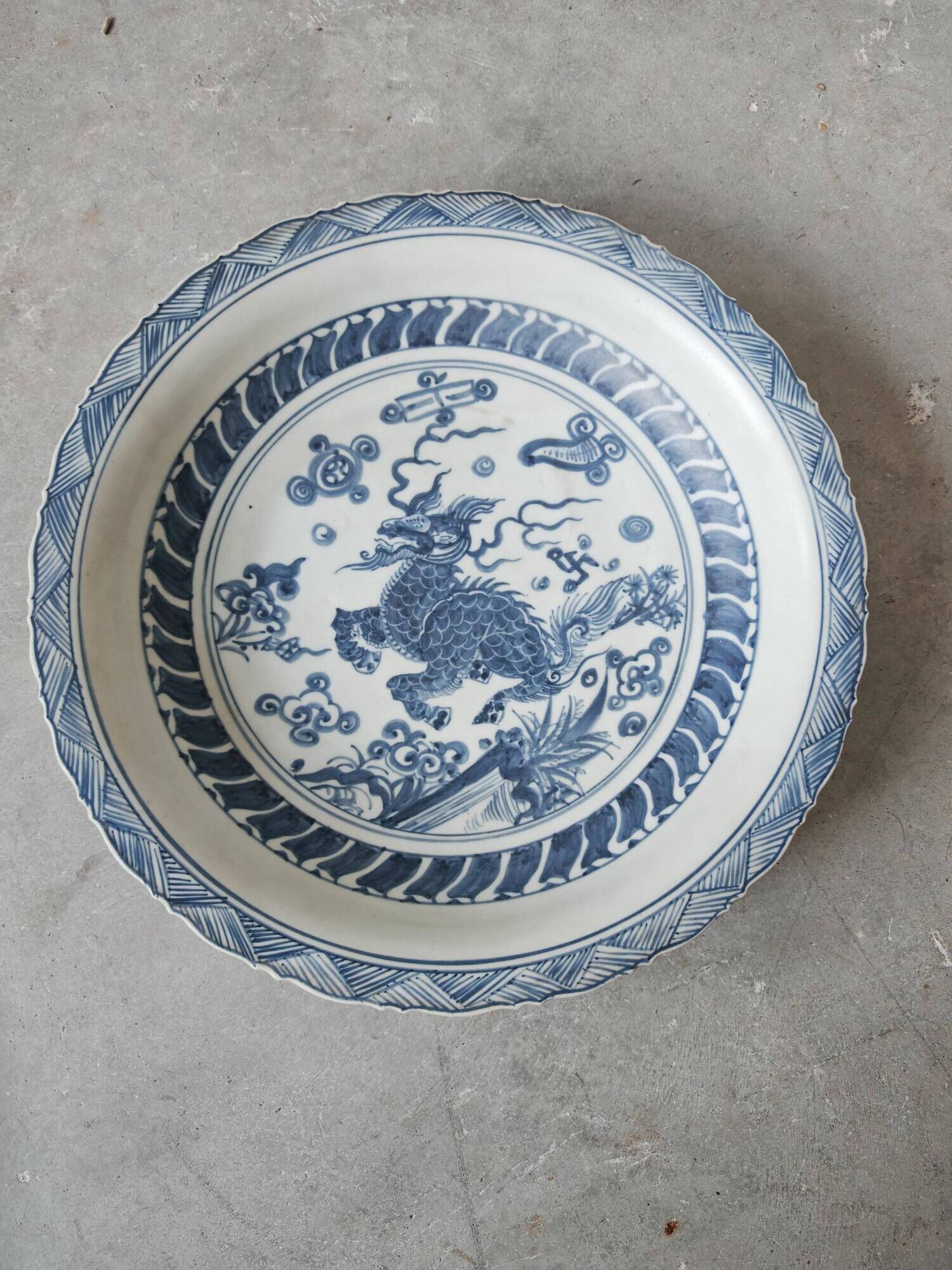 Pair of antique Chinese decorative plates with dragon motif.