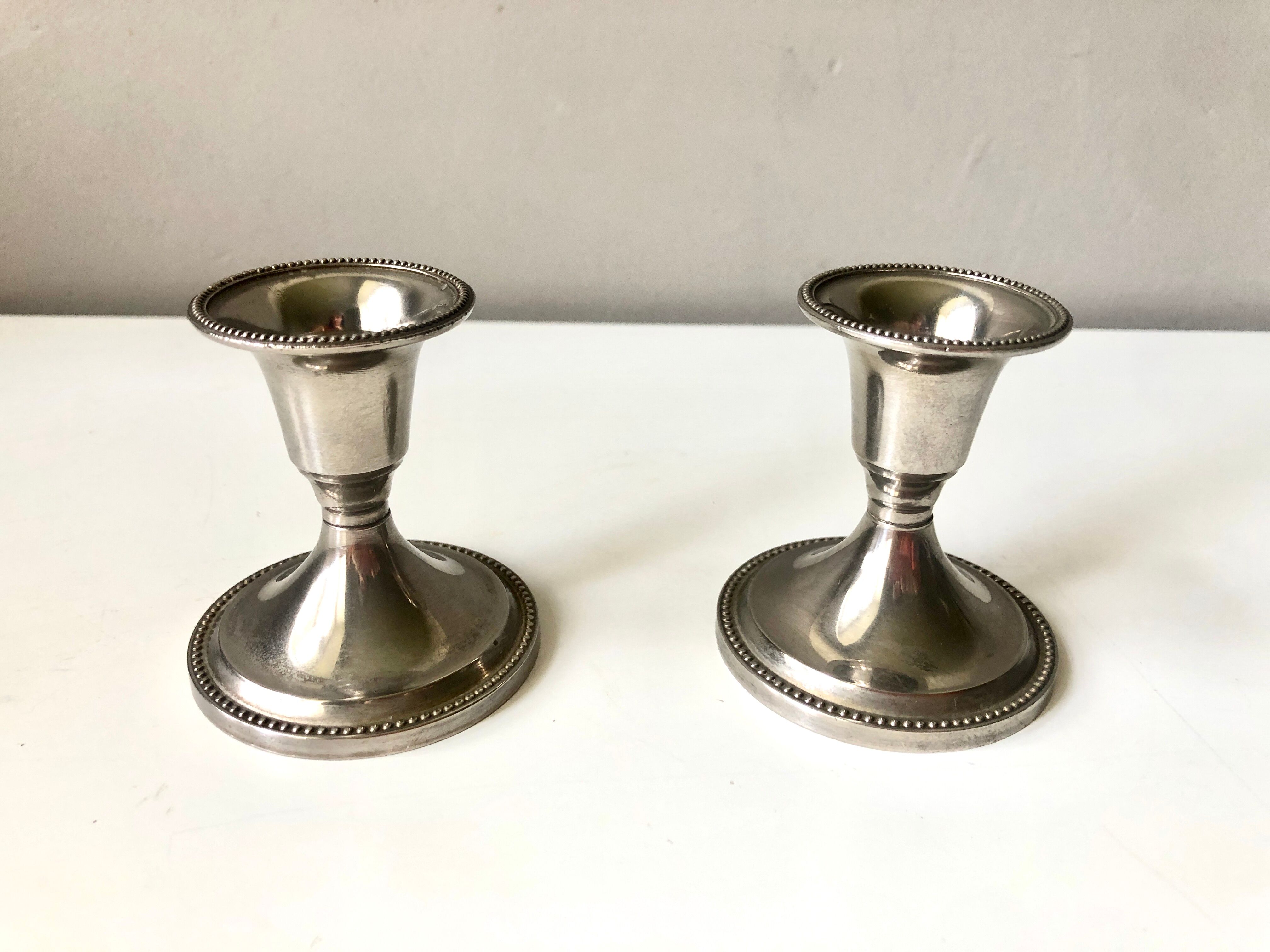 Pair of silver metal candle holders
