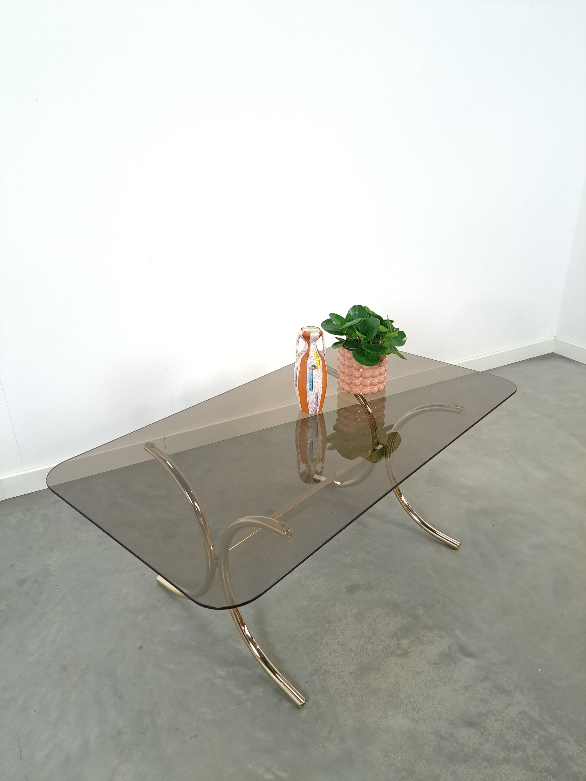 Smoked glass coffee table with gold-coloured legs from Sweden