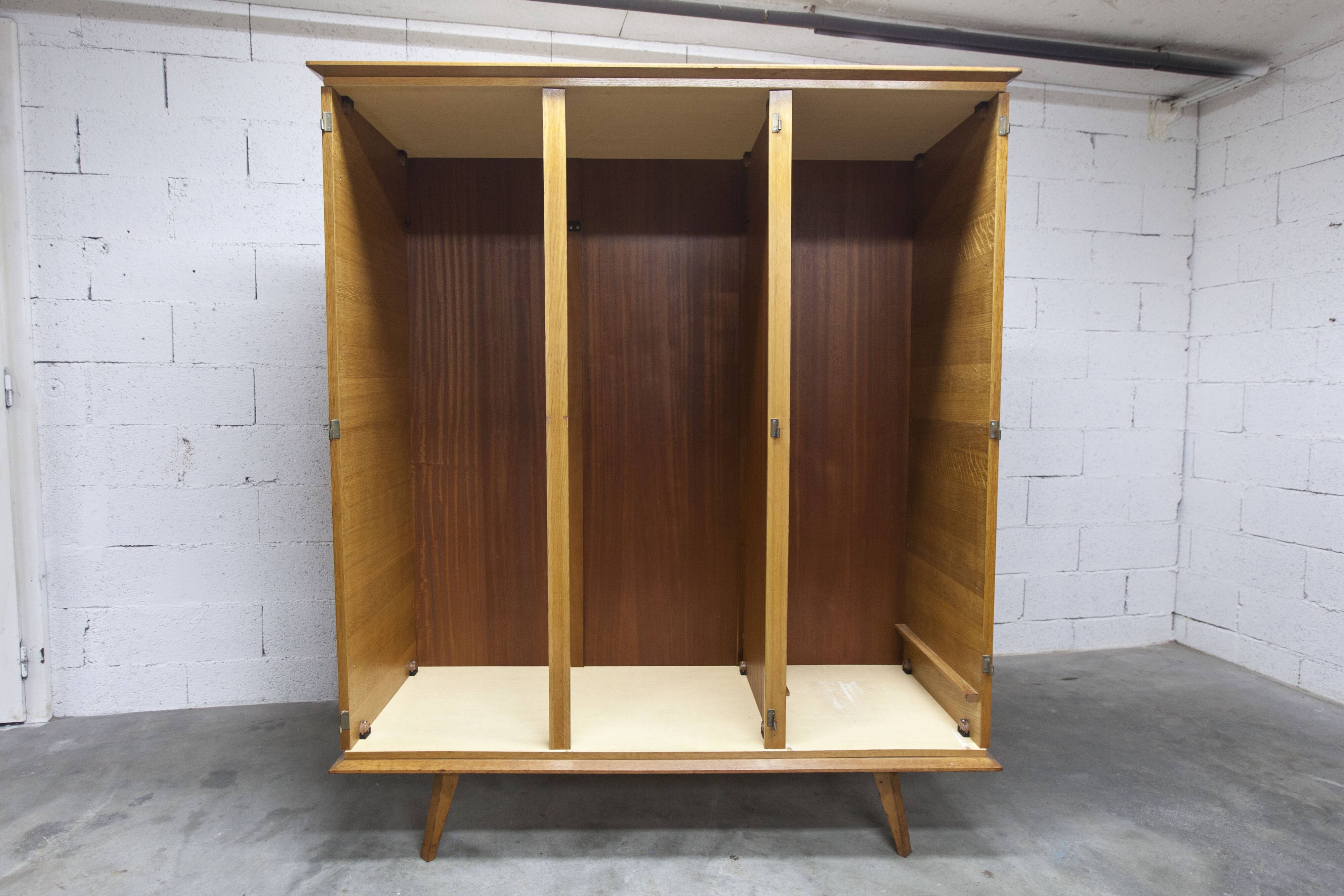 French wardrobe with tapered legs, 3 doors, 1 mirror (27*130), and 1 drawer.
