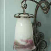 Wall lamp in wrought iron with a pink tulip glass globe by Muller glassworks.