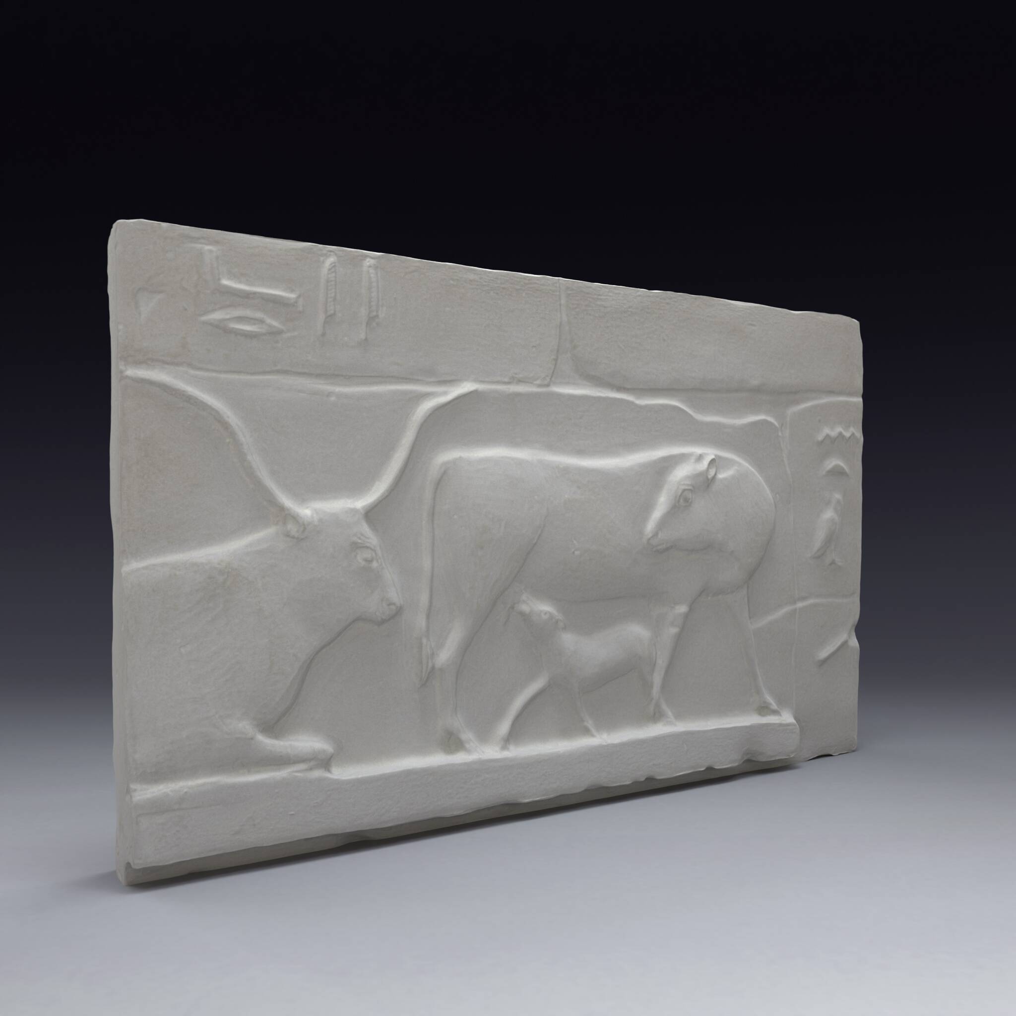 Plaster depicting two cows and a calf, based on an Egyptian fresco.