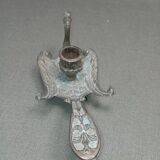 Chiselled brass candlestick in the shape of a peacock.