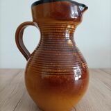 Orange glazed ceramic pitcher