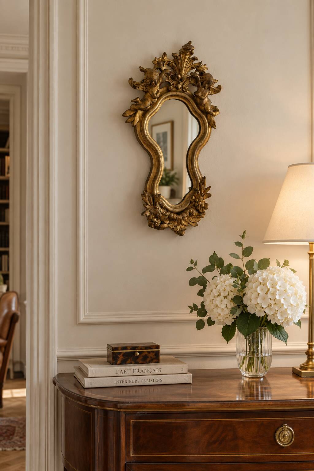 Antique rococo mirror with putti, gilded carved wood and stucco frame, 19th century.