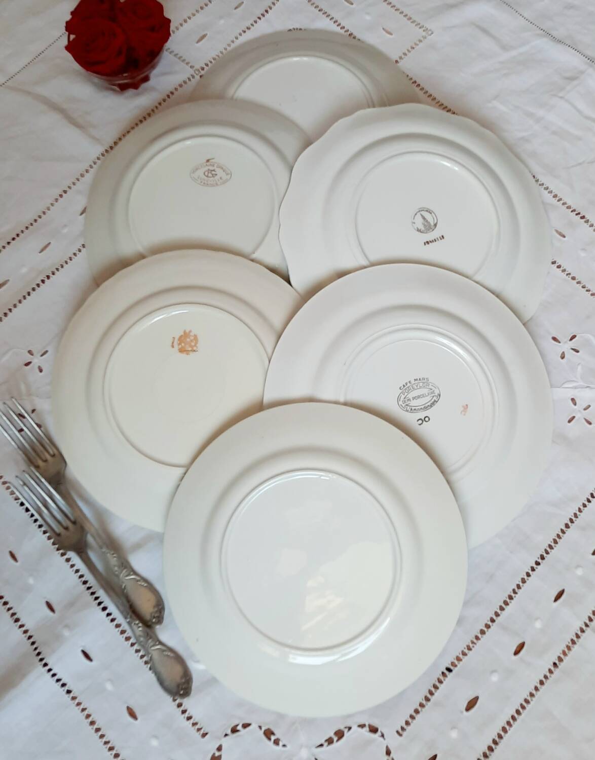 Old mismatched earthenware dinner plates with gold accompanied by a dish