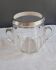 Twisted moulded glass bistro champagne bucket with a silver metal collar.
