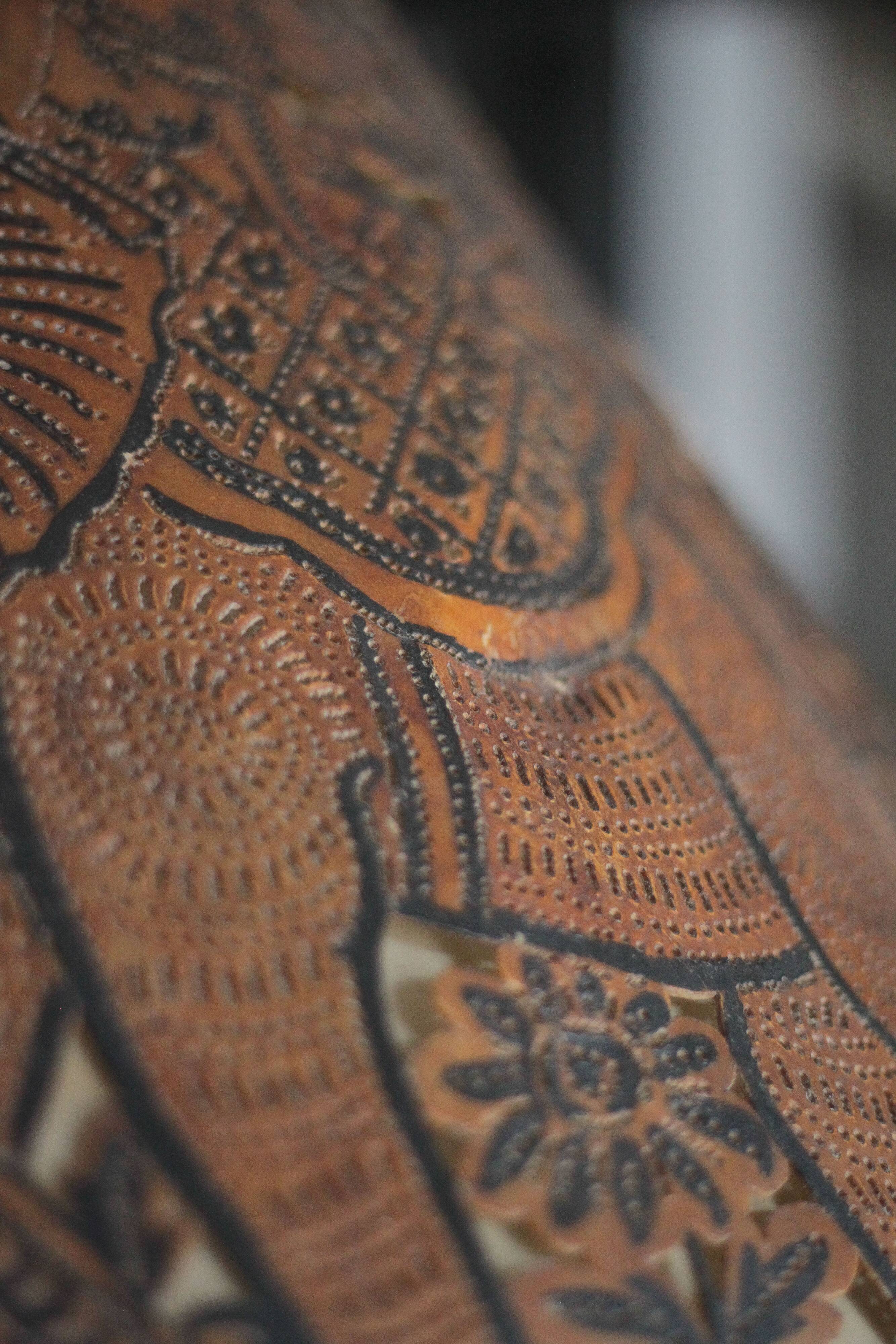 Liane and metal floor lamp with perforated leather shade featuring elephant patterns, lise.