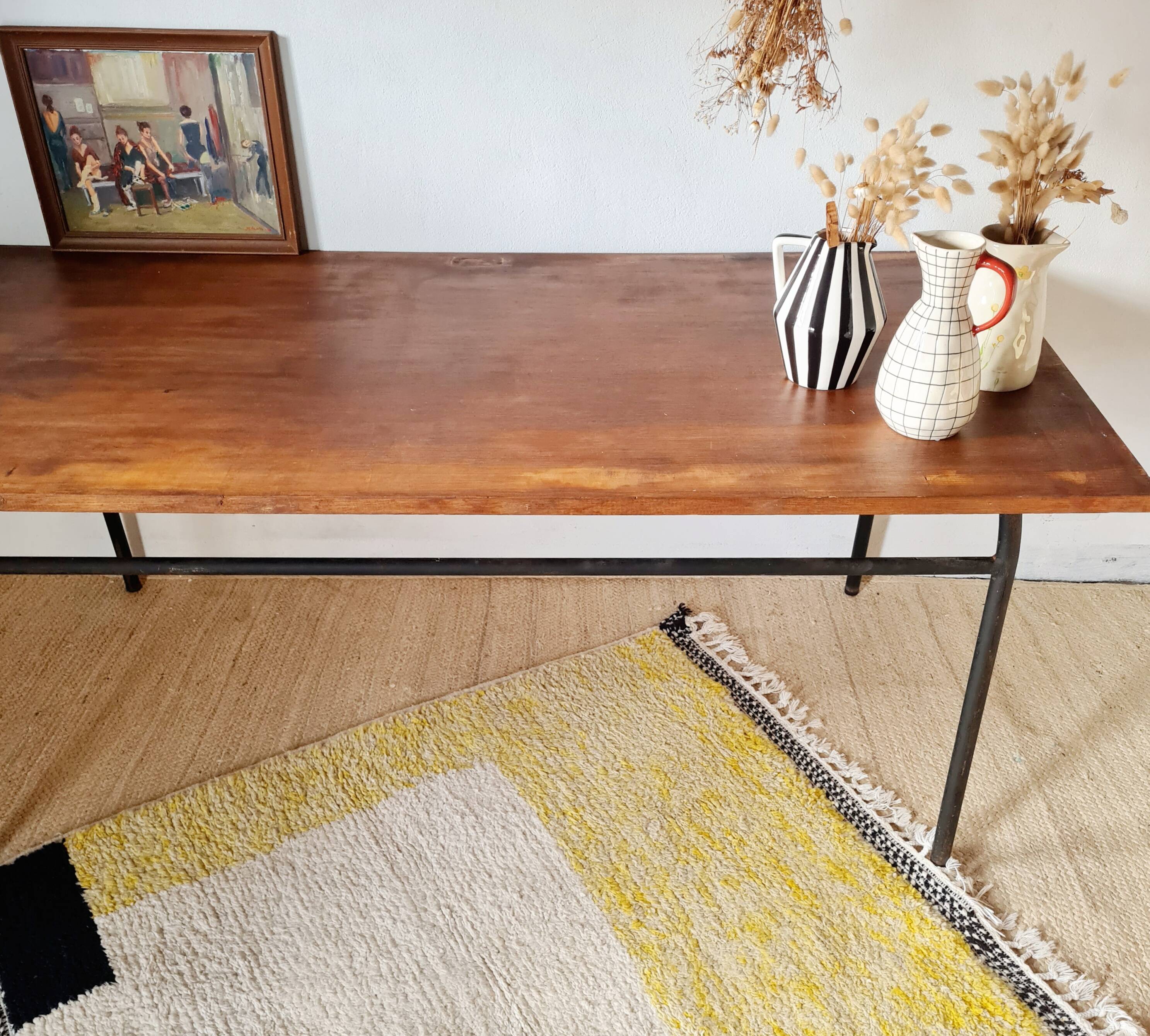 Metal tubular base table with a wooden top.