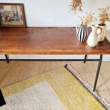 Metal tubular base table with a wooden top.