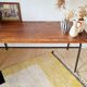 Metal tubular leg table with a wooden top.