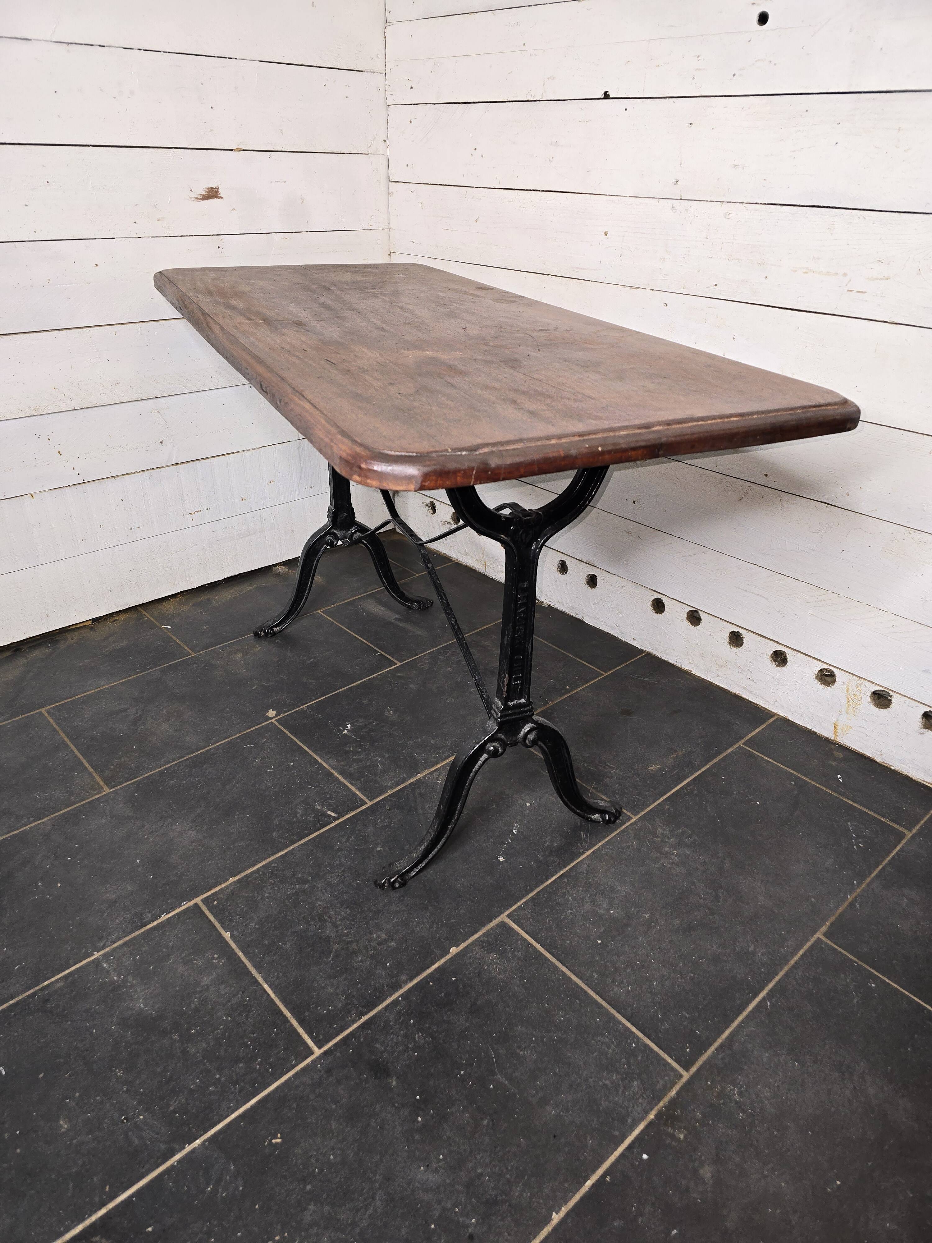 Bistro table with cast iron legs and solid wood top