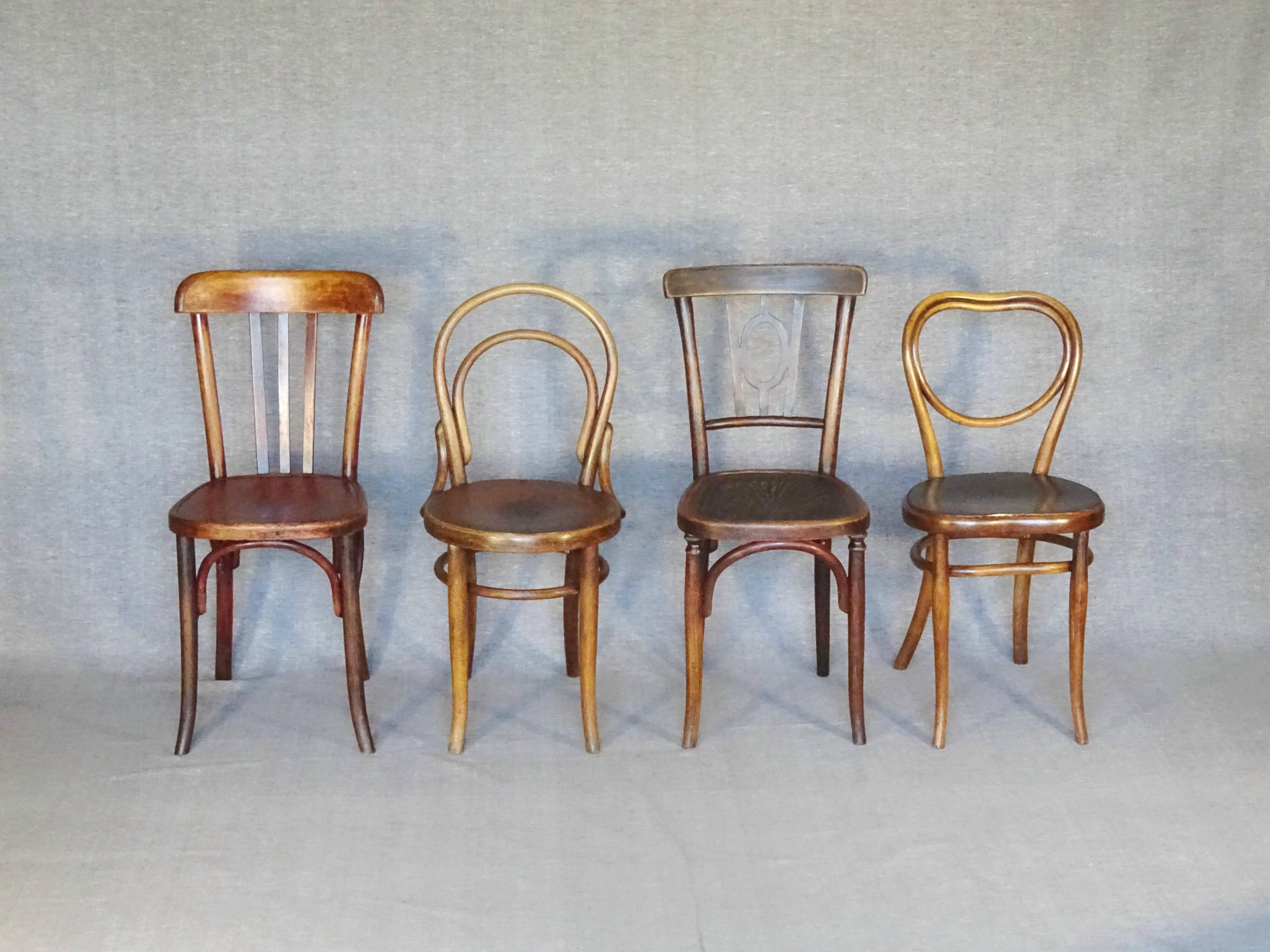 Set of 4 mismatched bistro chairs, 1900 to 1930 with wooden seats, Thonet, Baumann
