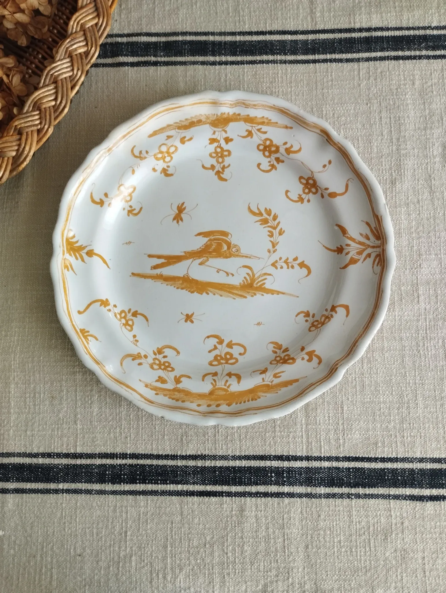 Pair of antique plates with a bird of paradise design in the style of Moustiers.
