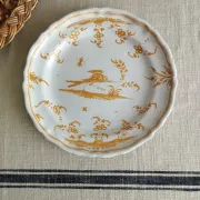 Pair of antique plates with a bird of paradise design in the style of Moustiers.