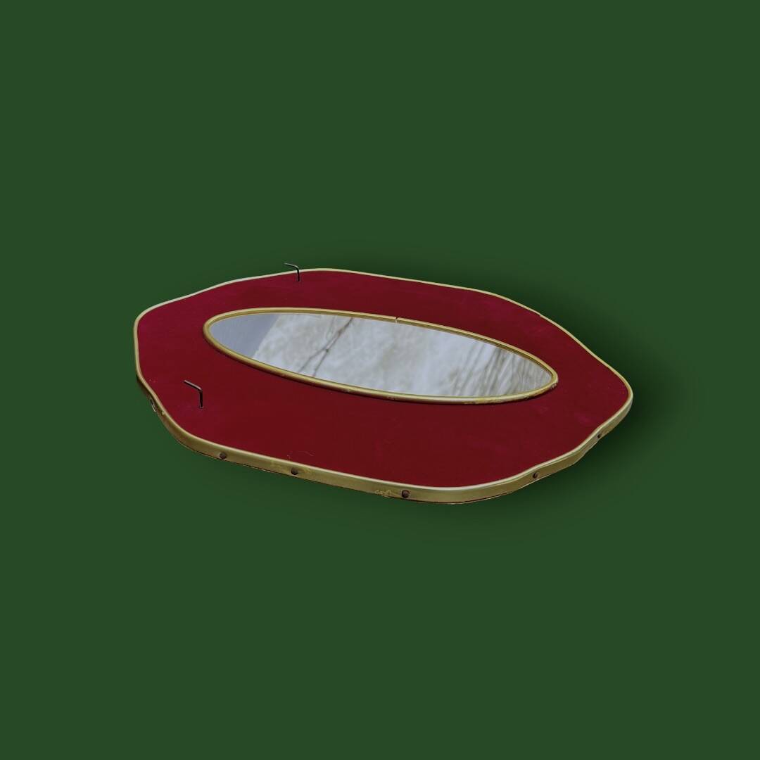 Oval wall mirror in burgundy velvet and brass – 1950s–1960s
