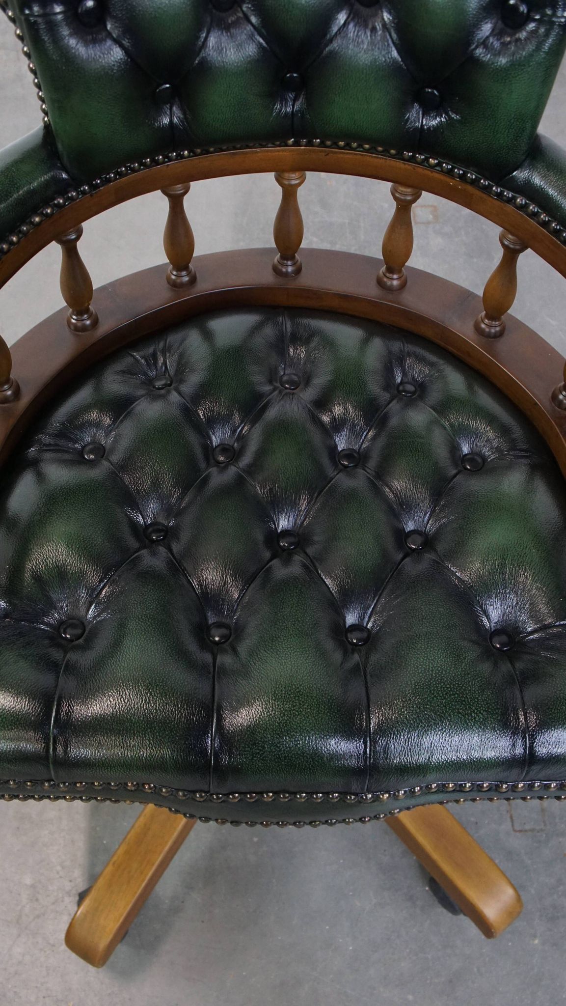 Dark green cowhide leather and wood chesterfield office chair on wheels