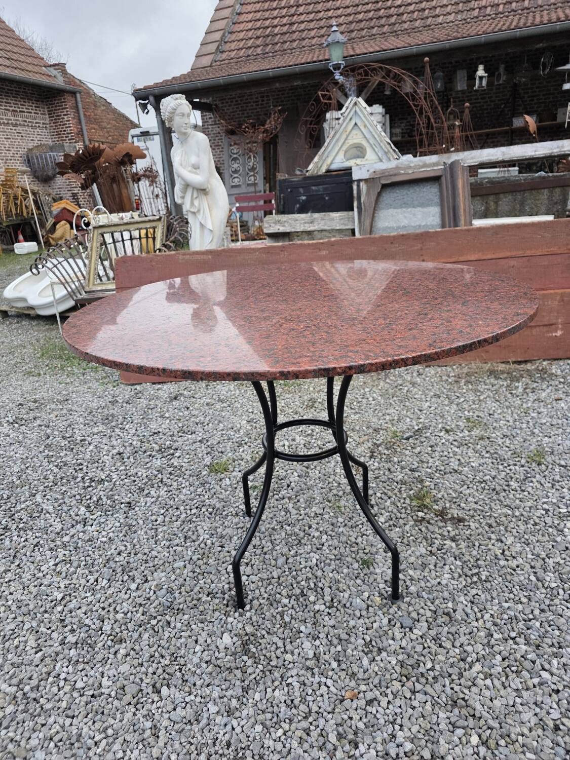 Round marble table with wrought iron base from the mid-20th century.