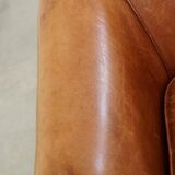 Very comfortable, elegant leather club armchair with a removable seat cushion and timeless design