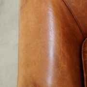 Very comfortable, elegant leather club armchair with a removable seat cushion and timeless design