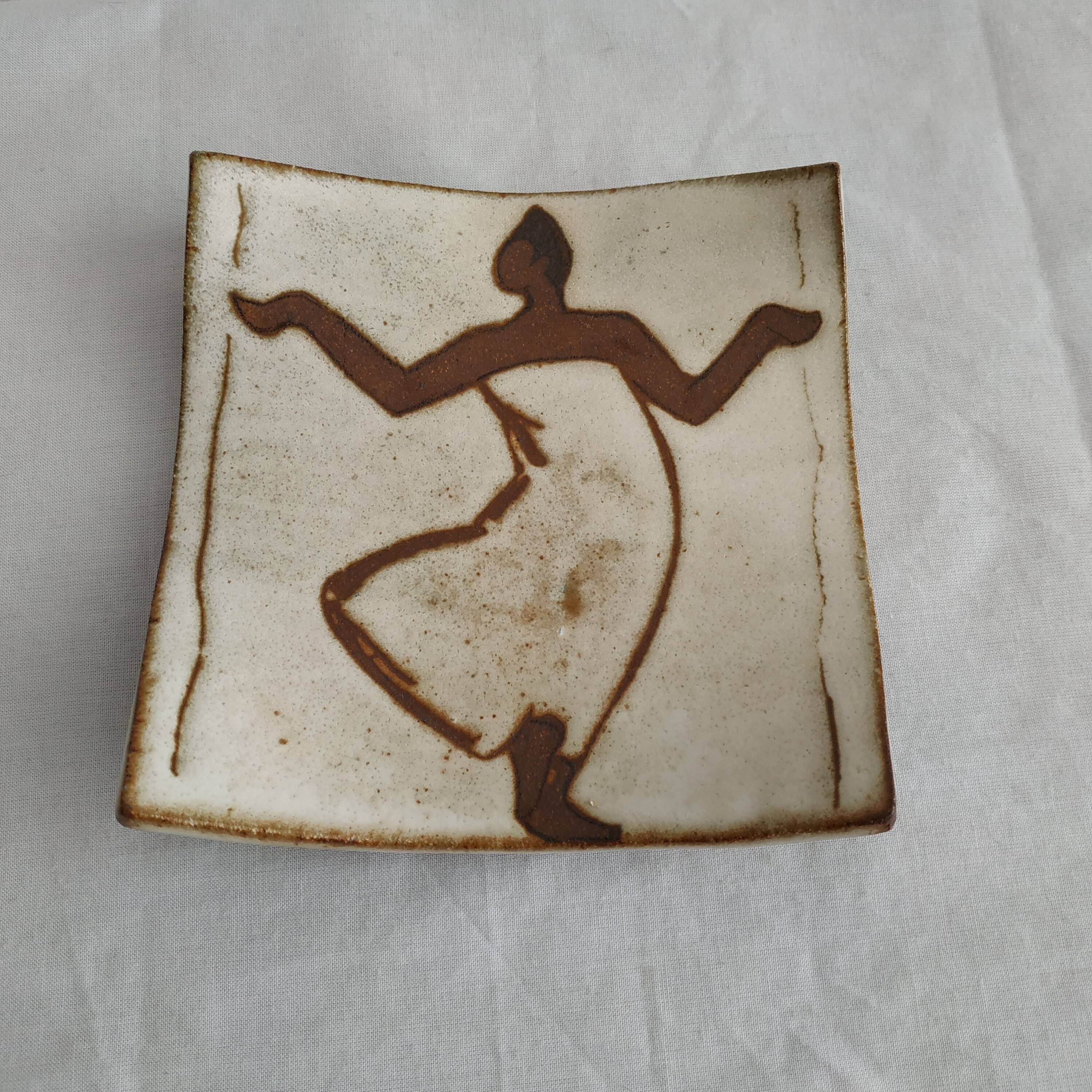Two terracotta bowls with ethnic decoration and vintage signature.