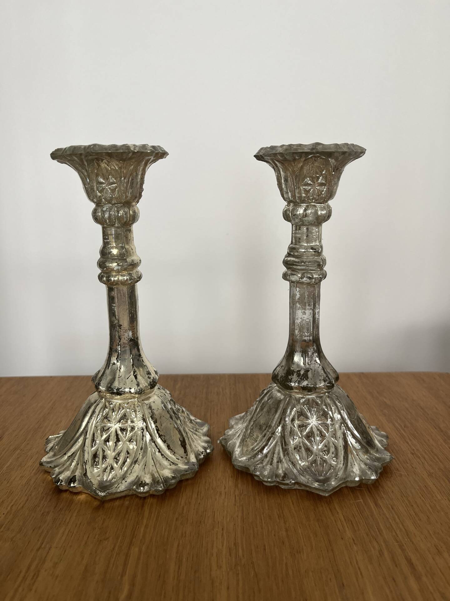 Pair of pressed glass candlesticks with silver plating.