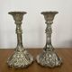 Pair of pressed glass candlesticks with silver plating.