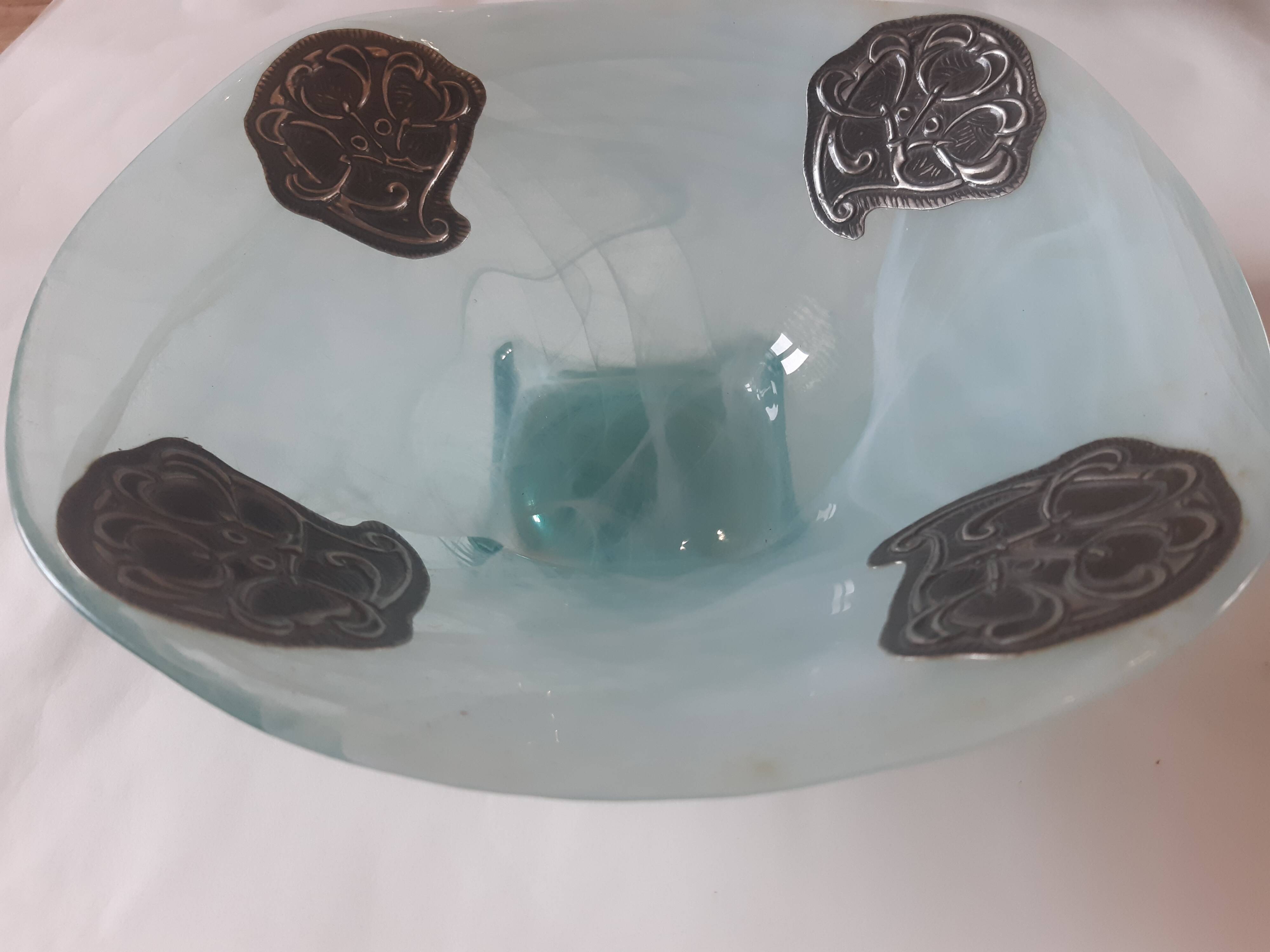Handcrafted glass fruit bowl with ribbed design set with pewter medallions.