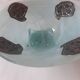 Handcrafted glass fruit bowl with ribbed design set with pewter medallions.