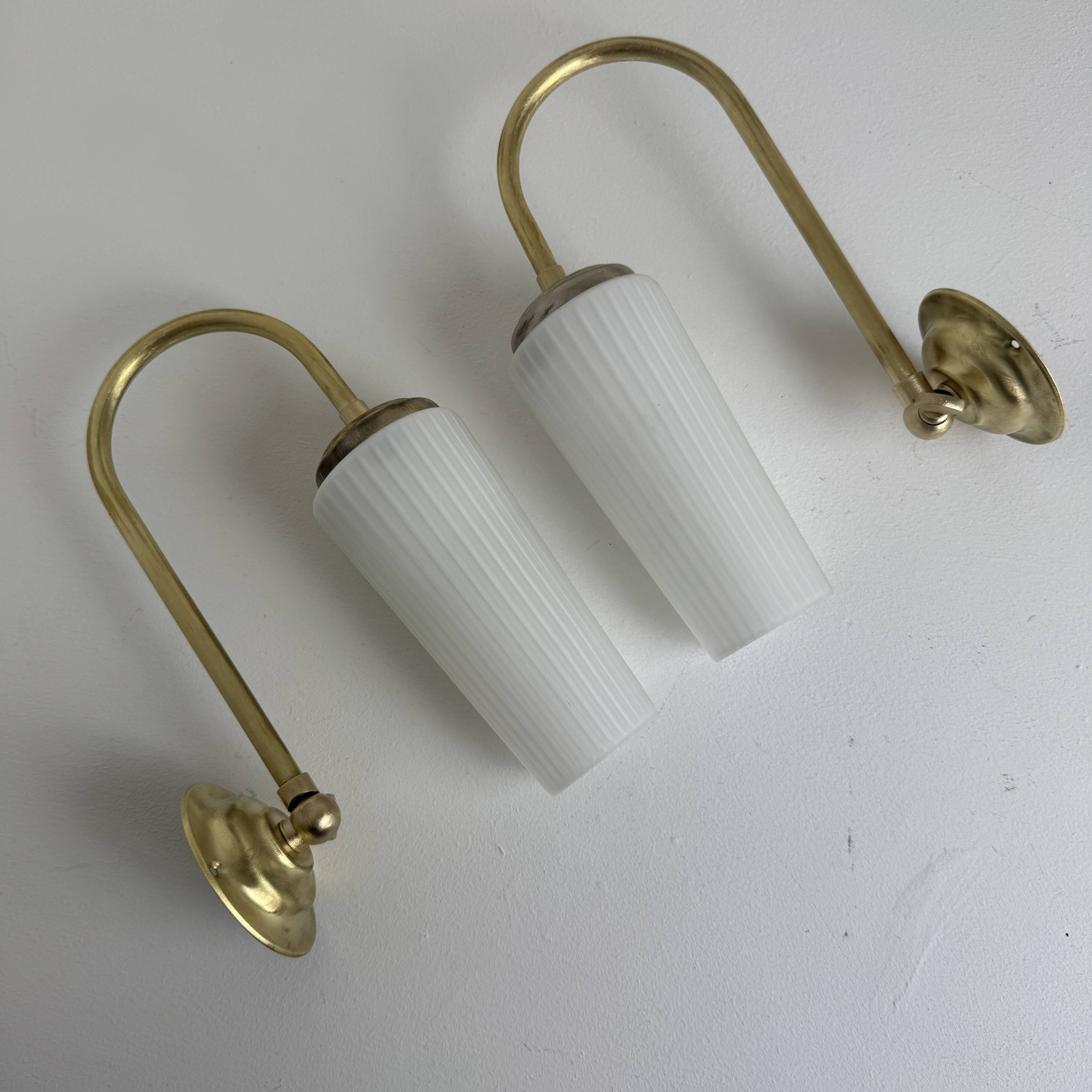 A pair of vintage opaline and brass wall lights