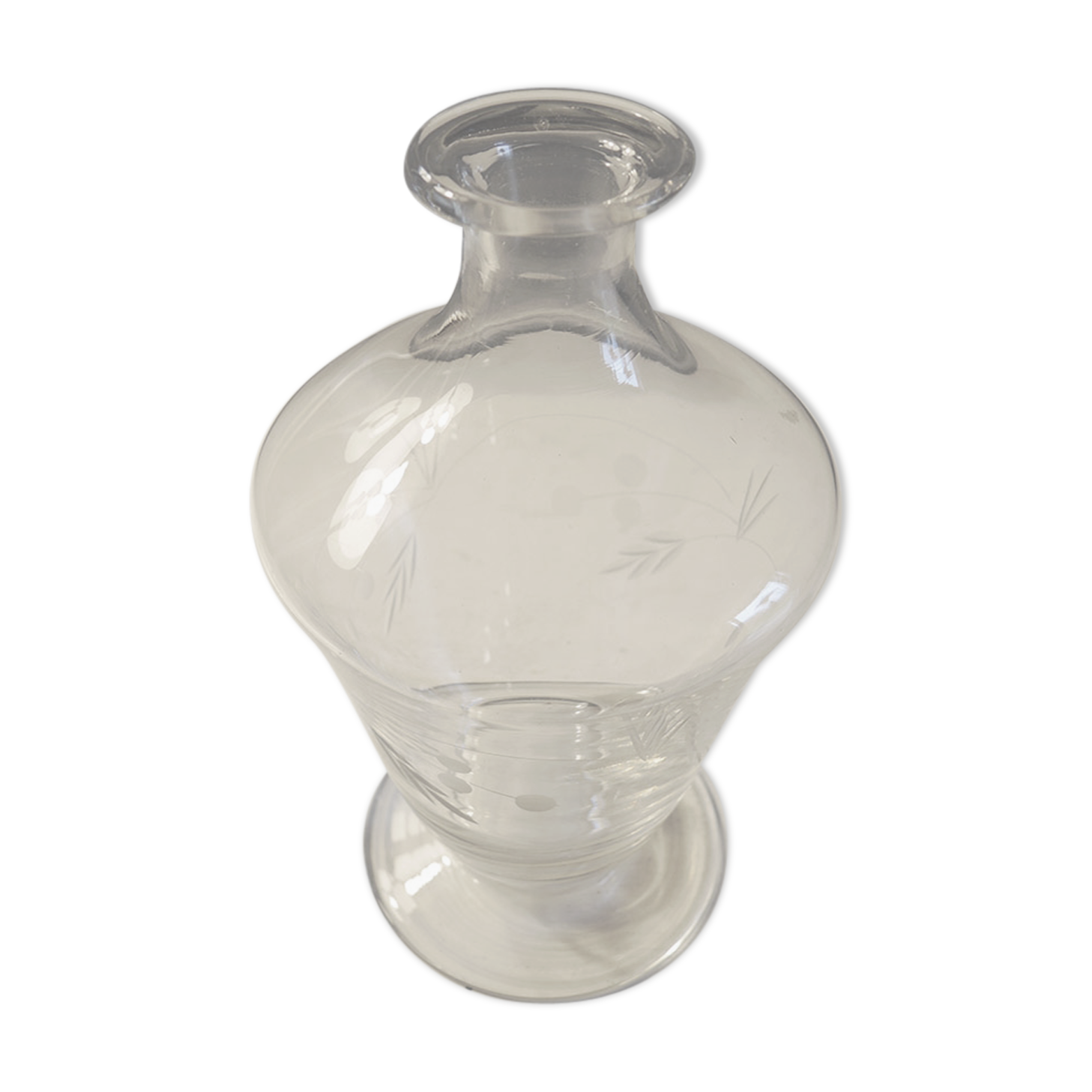Old carafe in engraved glass vegetal decoration