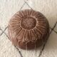 Moroccan-style brown leather pouf